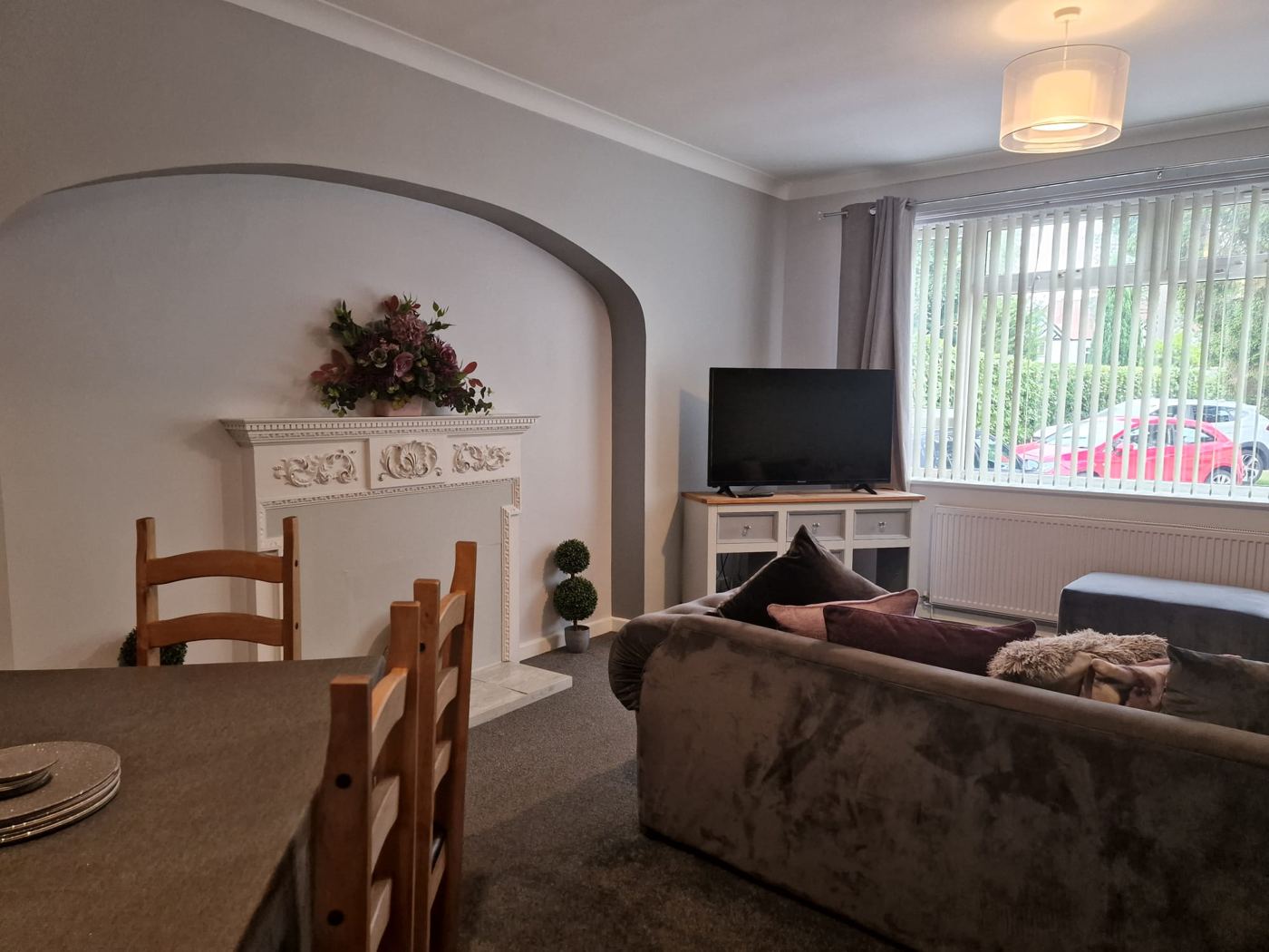 Dining and lounge area with sofa and television