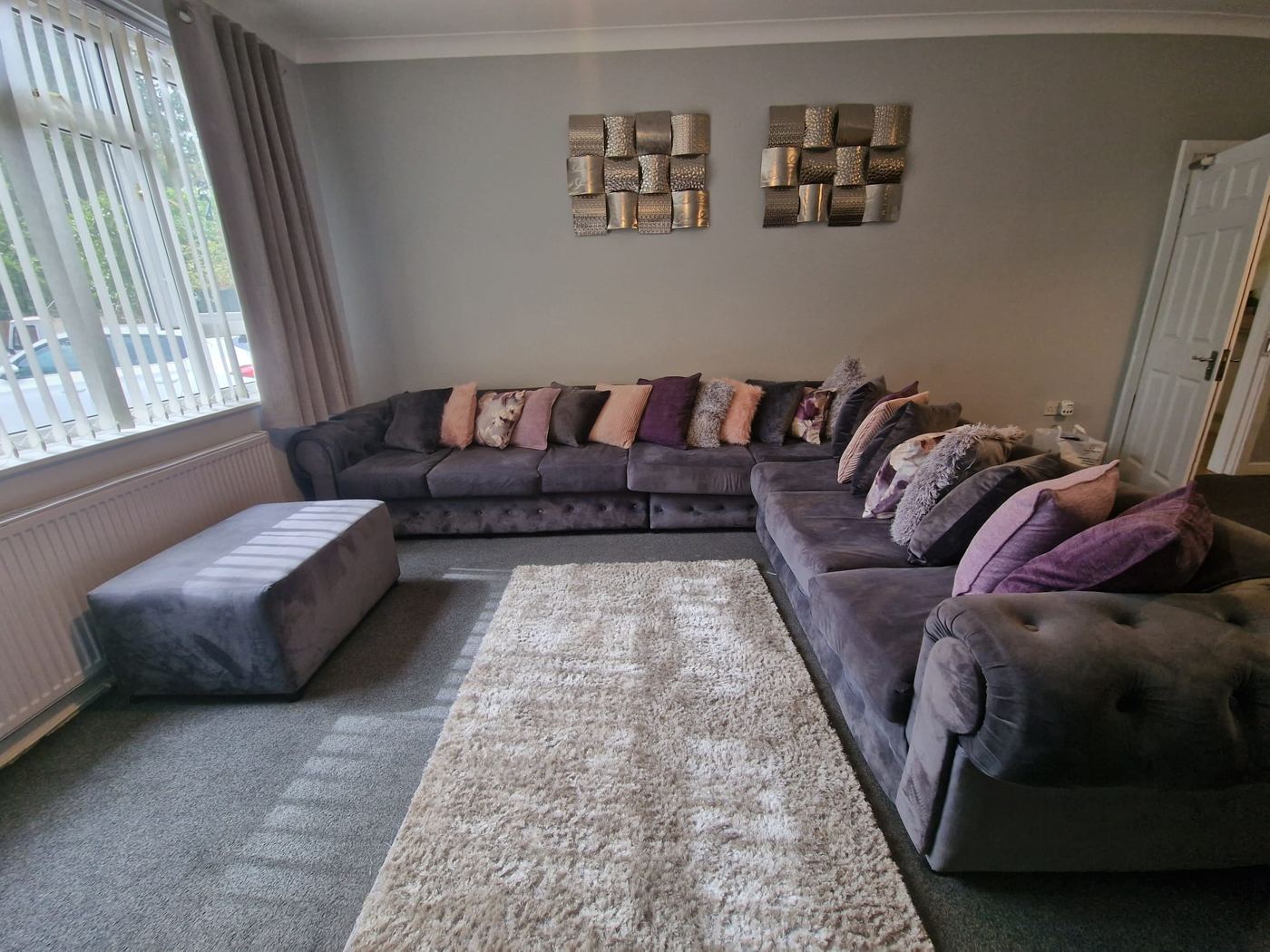 Large living room with corner sofa and cushions